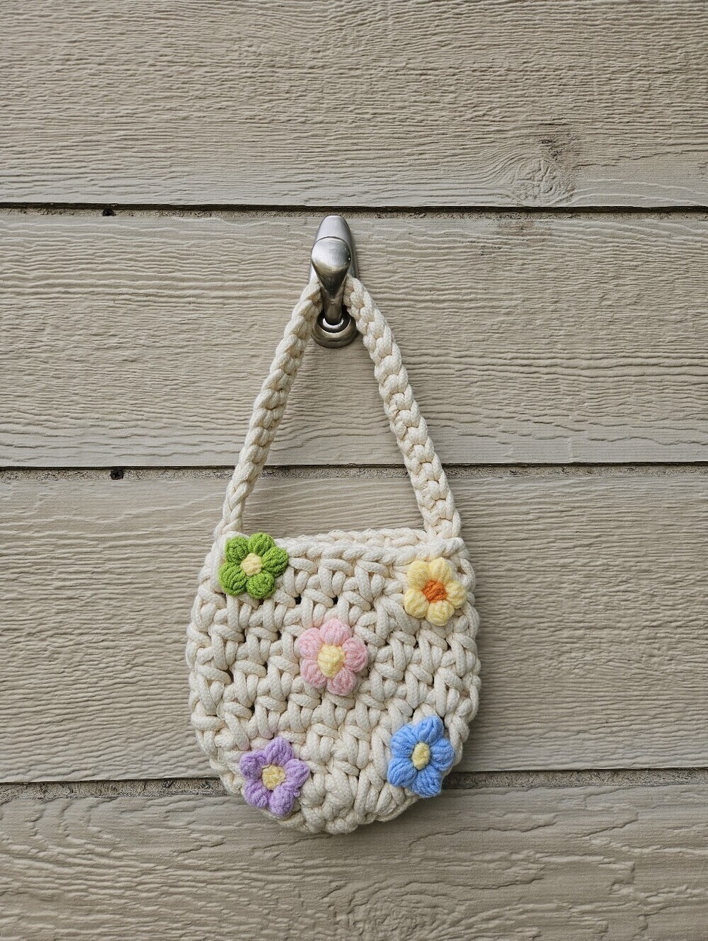 cream colored chunky crochet bag with flowers